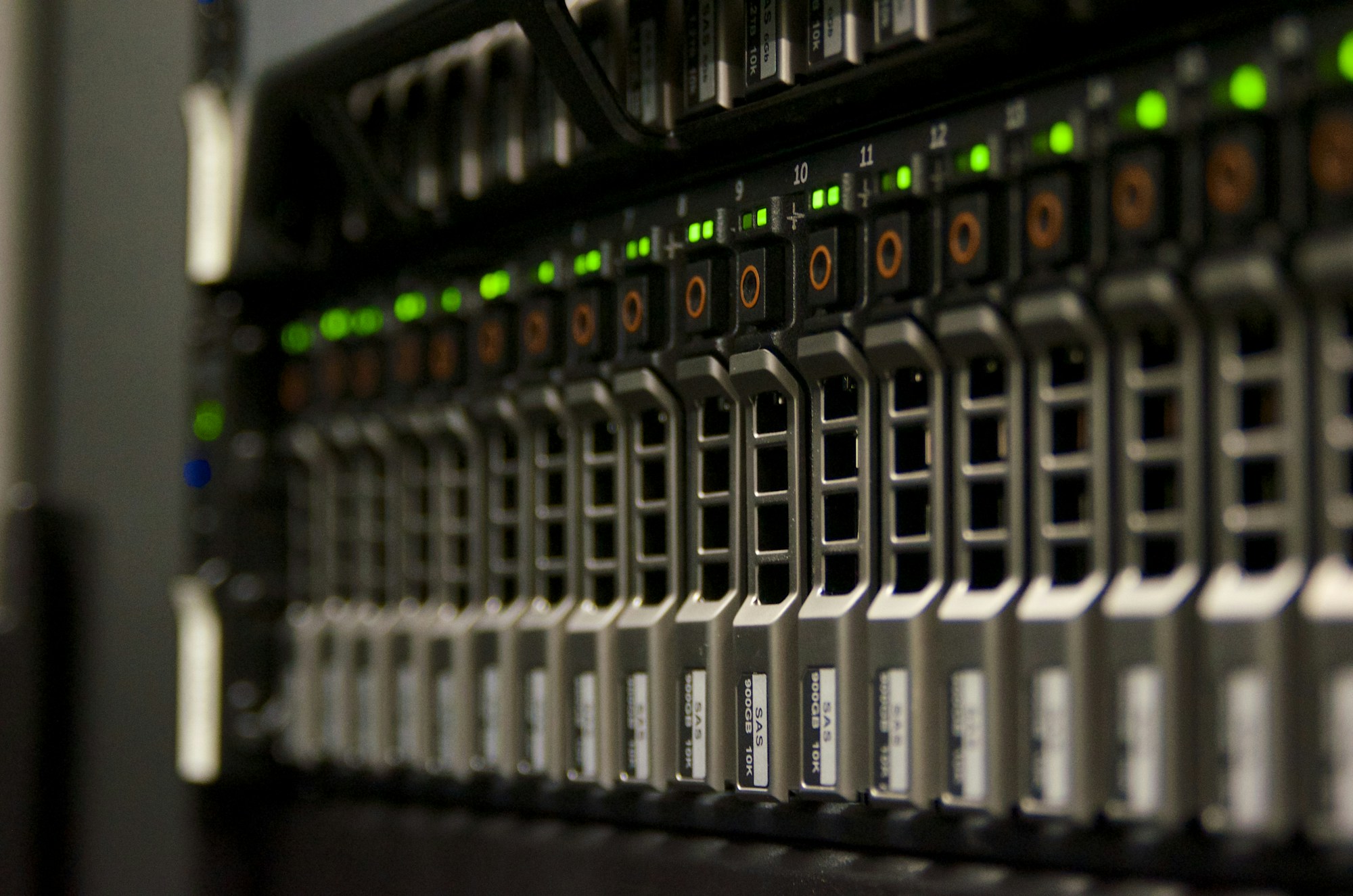Server racks with dense green status lights in a data center.